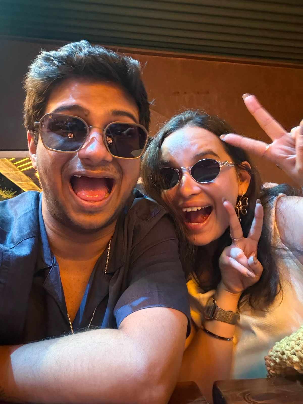 Vatsal and Gunjan in sunglasses pulling goofy faces in a selfie